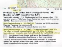 Datum statement and UTM zone, showing both the current NAD 83 value and the superseded NAD 27 value for the same corner