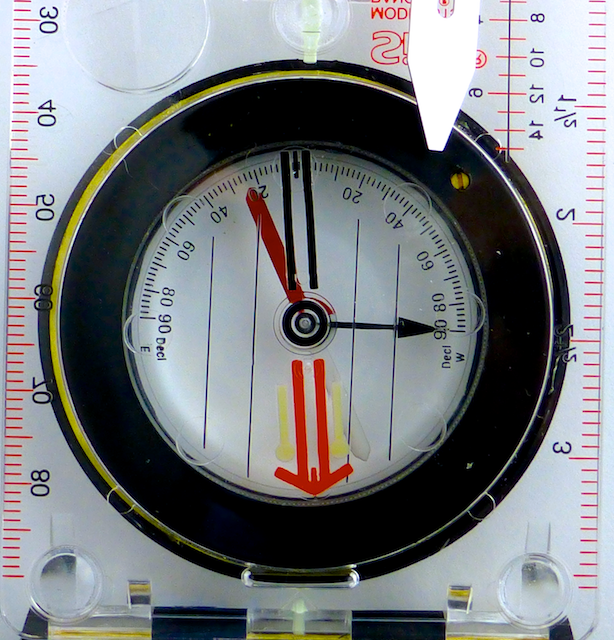 Bottom view: the small adjustment screw and gear that drives the orienting arrow